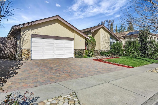 view of front facade with a front lawn and a garage