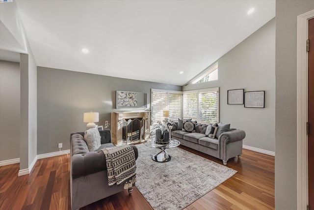 living room featuring lofted ceiling and hardwood / wood-style flooring