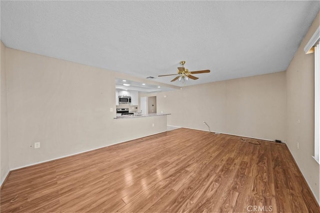 unfurnished living room featuring ceiling fan and light hardwood / wood-style flooring