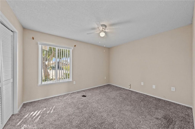 unfurnished bedroom with carpet flooring, a textured ceiling, ceiling fan, and a closet