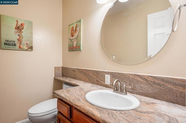 bathroom featuring toilet and vanity