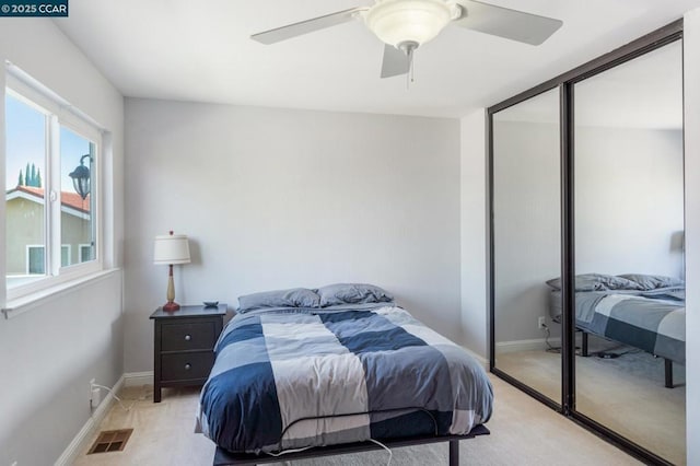 carpeted bedroom with a closet and ceiling fan