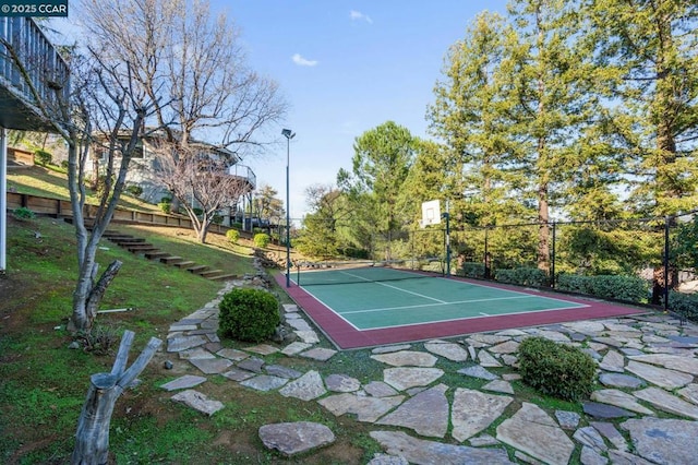 view of tennis court featuring basketball hoop