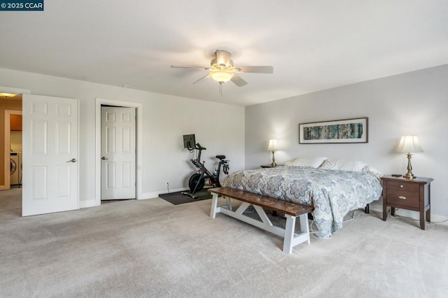 bedroom featuring ceiling fan, washer / clothes dryer, and light carpet