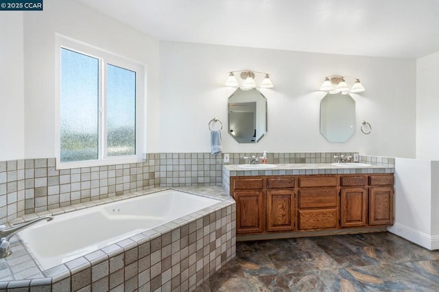 bathroom with vanity and tiled tub