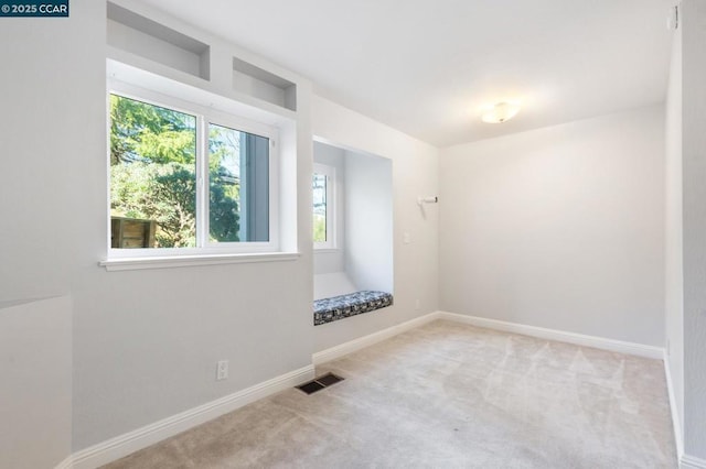 unfurnished room with light colored carpet