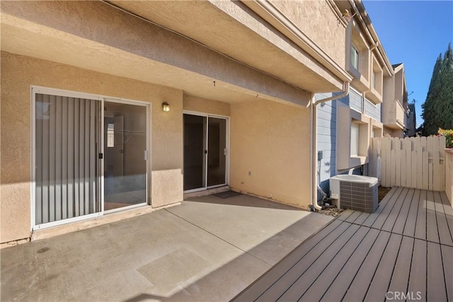 wooden deck with a patio and central AC