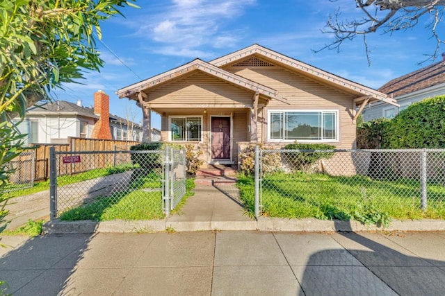 bungalow-style home with a front yard