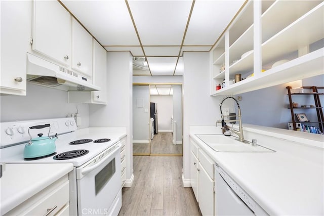 kitchen with white appliances, white cabinets, light hardwood / wood-style floors, and sink