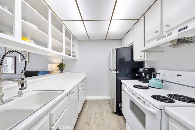 kitchen featuring white appliances, white cabinets, light hardwood / wood-style flooring, and sink