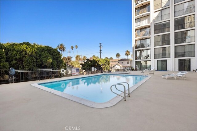 view of swimming pool with a patio