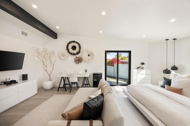 bedroom with access to outside, light hardwood / wood-style floors, and beam ceiling