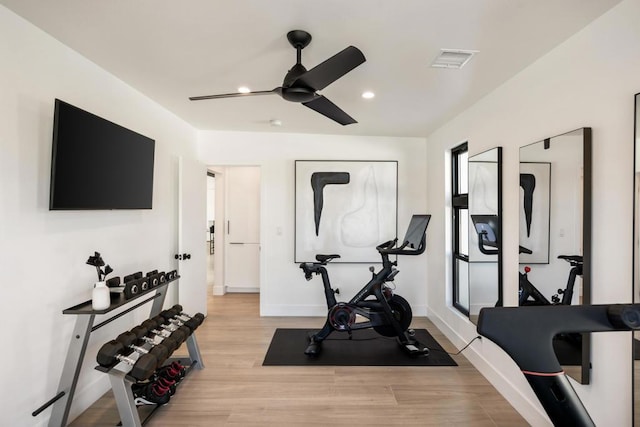 workout area featuring ceiling fan and light hardwood / wood-style floors