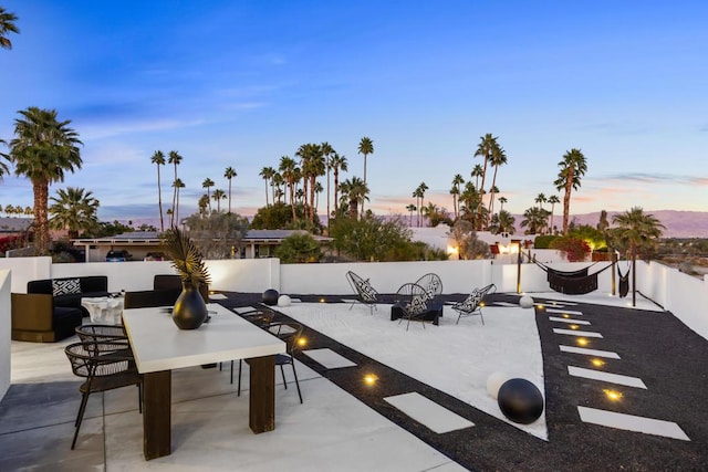 view of patio terrace at dusk