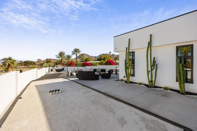 view of patio / terrace featuring an outdoor living space and a mountain view