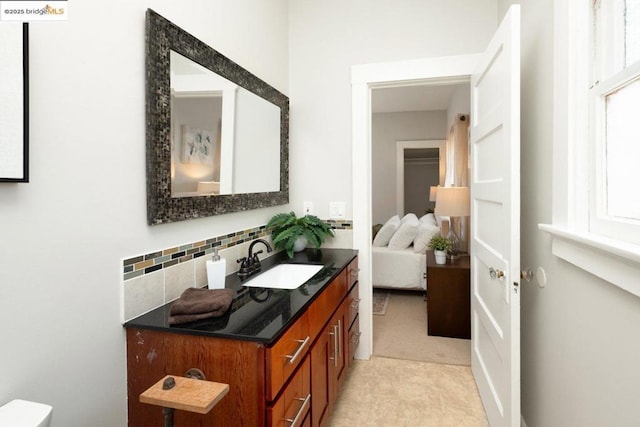 bathroom featuring vanity and decorative backsplash