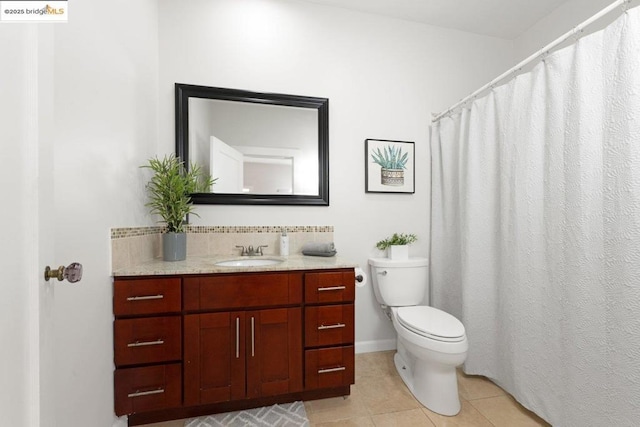 bathroom with toilet, tile patterned floors, and vanity