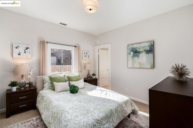 bedroom with light colored carpet