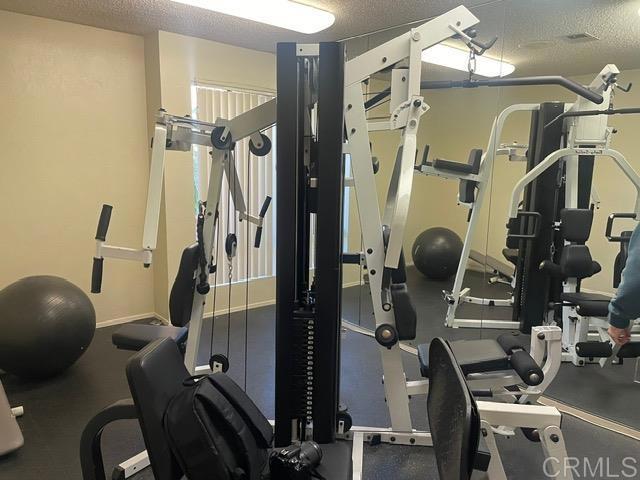 workout room featuring a textured ceiling