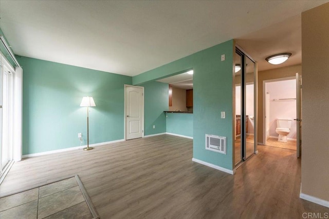 unfurnished living room with wood-type flooring