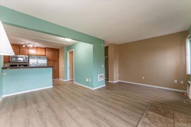 unfurnished living room featuring light wood-type flooring