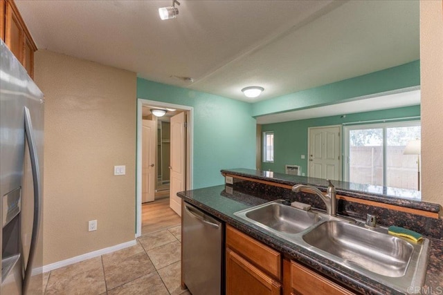 kitchen featuring sink, stainless steel appliances, and light tile patterned floors