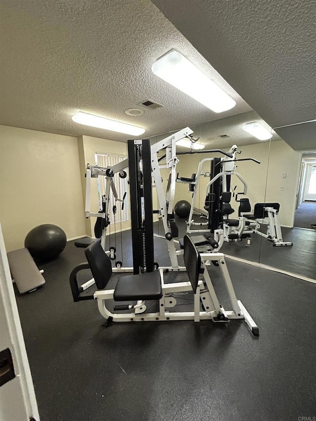 gym with a textured ceiling