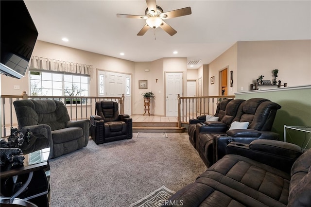 living room with ceiling fan and carpet