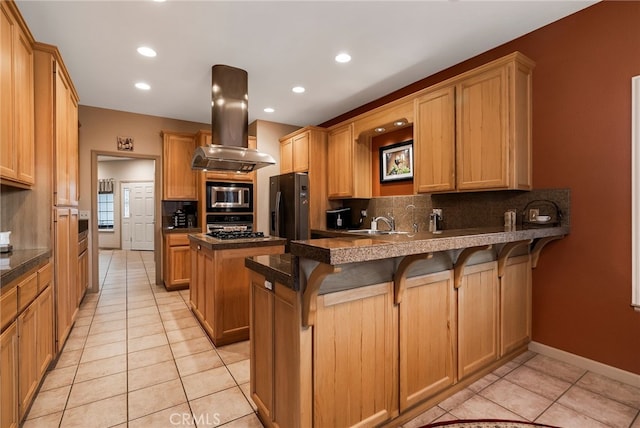 kitchen featuring black refrigerator with ice dispenser, a kitchen breakfast bar, light tile patterned floors, island range hood, and stainless steel microwave