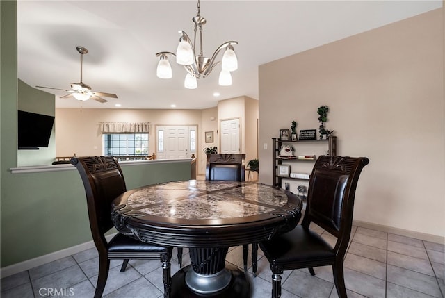 dining area with ceiling fan with notable chandelier and light tile patterned flooring