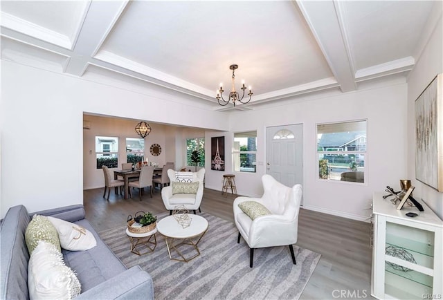 living room with wood-type flooring, a wealth of natural light, and an inviting chandelier