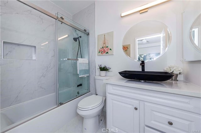 full bathroom featuring bath / shower combo with glass door, toilet, and vanity