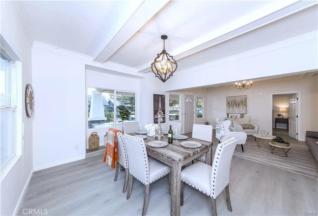 dining room with a chandelier, hardwood / wood-style flooring, and beamed ceiling