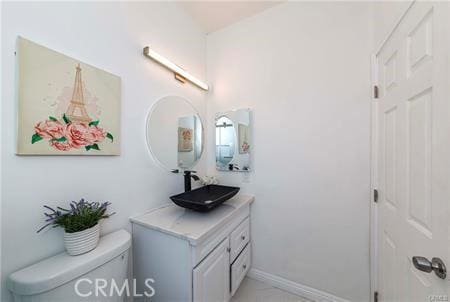 bathroom featuring toilet and vanity