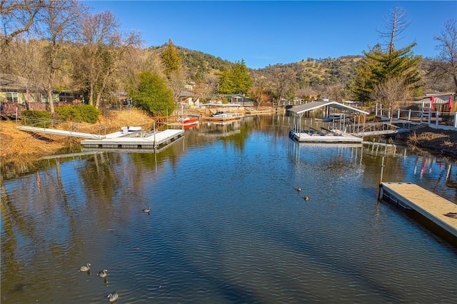view of dock with a water and mountain view