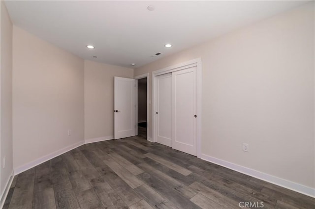 unfurnished bedroom with dark wood-style floors, recessed lighting, and baseboards