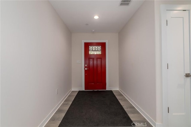 doorway featuring recessed lighting, visible vents, baseboards, and wood finished floors