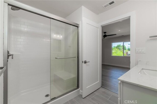 bathroom featuring an enclosed shower, vanity, tile patterned flooring, and ceiling fan