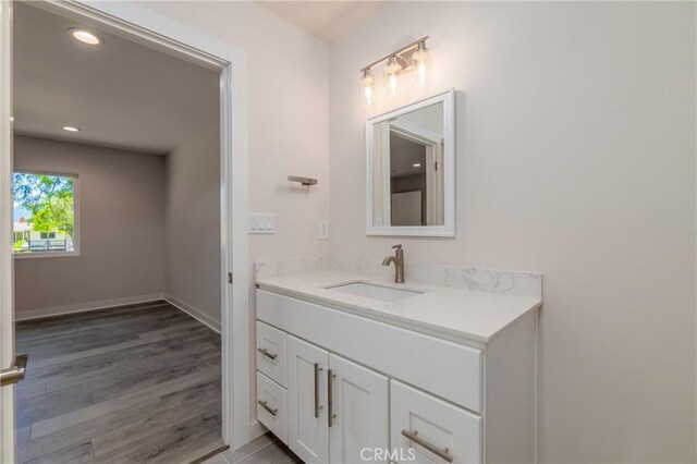 bathroom featuring wood-type flooring and vanity