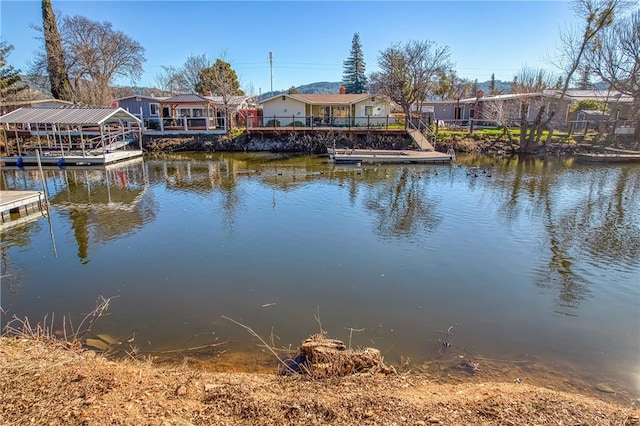 water view with a floating dock and a residential view