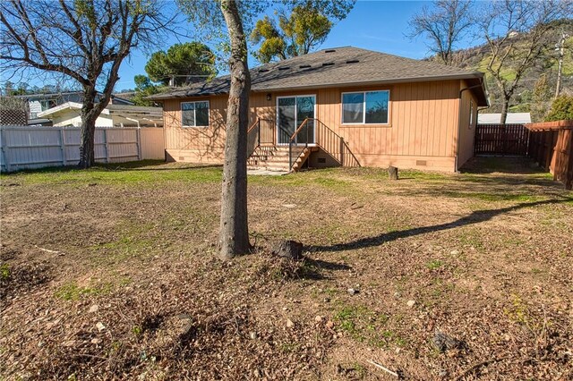 rear view of property with a yard