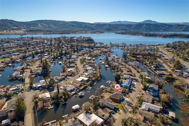 drone / aerial view featuring a water and mountain view