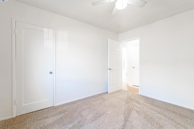 unfurnished bedroom featuring ceiling fan, a closet, and carpet floors