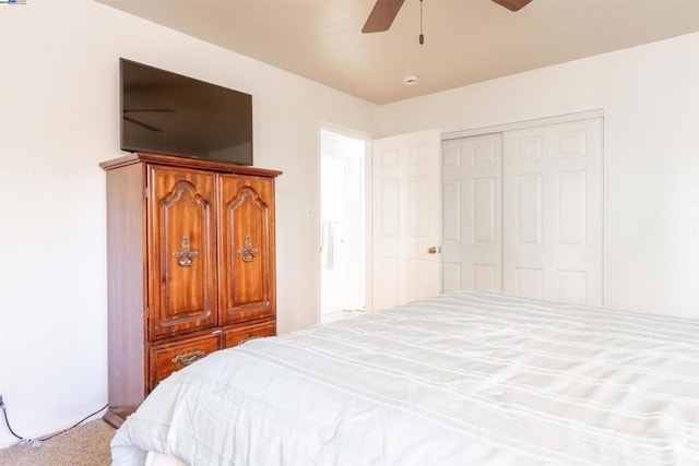 carpeted bedroom featuring ceiling fan and a closet