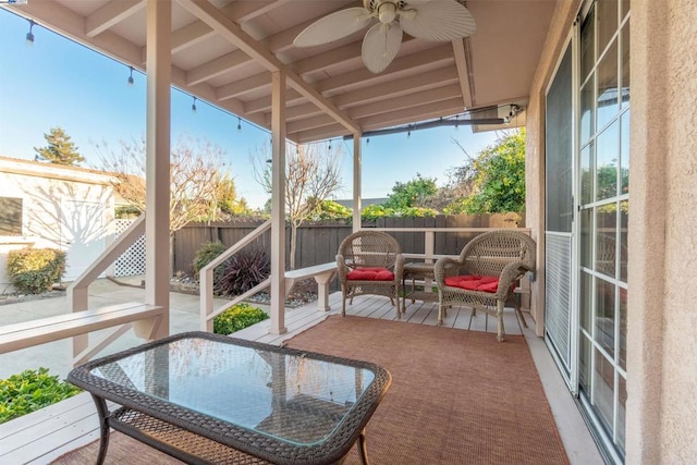 sunroom / solarium featuring ceiling fan