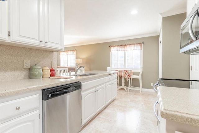 kitchen with stainless steel appliances, ornamental molding, white cabinets, and tasteful backsplash