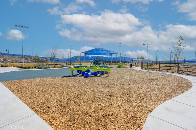 view of playground featuring a mountain view