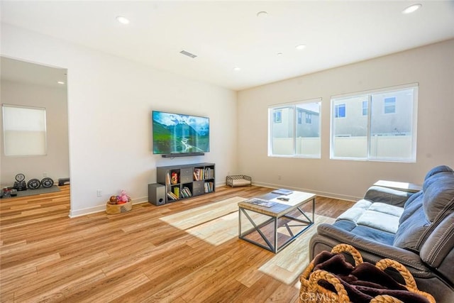 living room featuring recessed lighting, baseboards, visible vents, and wood finished floors