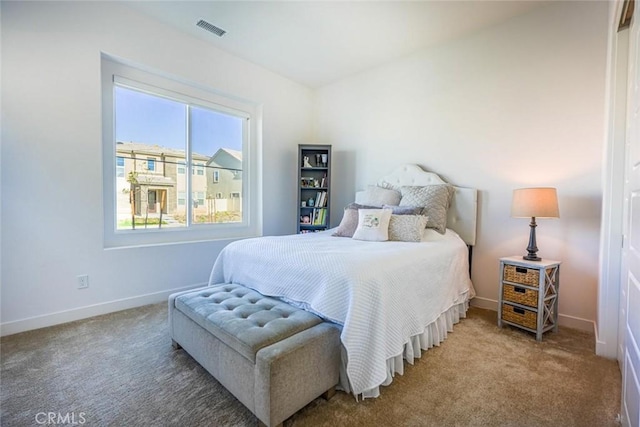 bedroom with visible vents, carpet, and baseboards