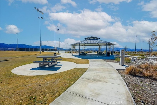 surrounding community with a gazebo, a lawn, and a mountain view
